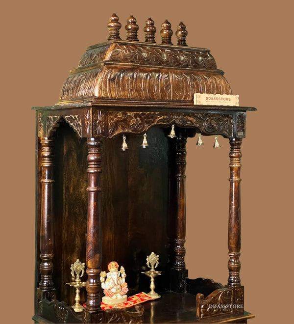 Wooden temple structure with decorative elements against a green wall